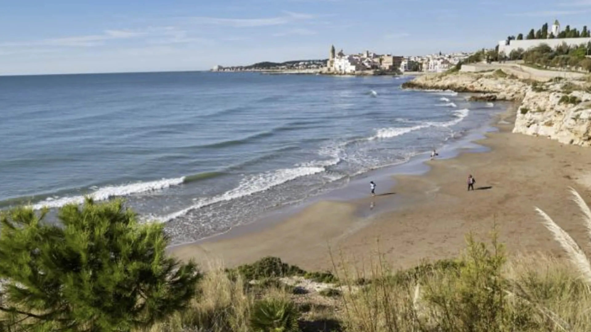 Balmins Beach Sitges with Mediterranean sea and rocky coastline