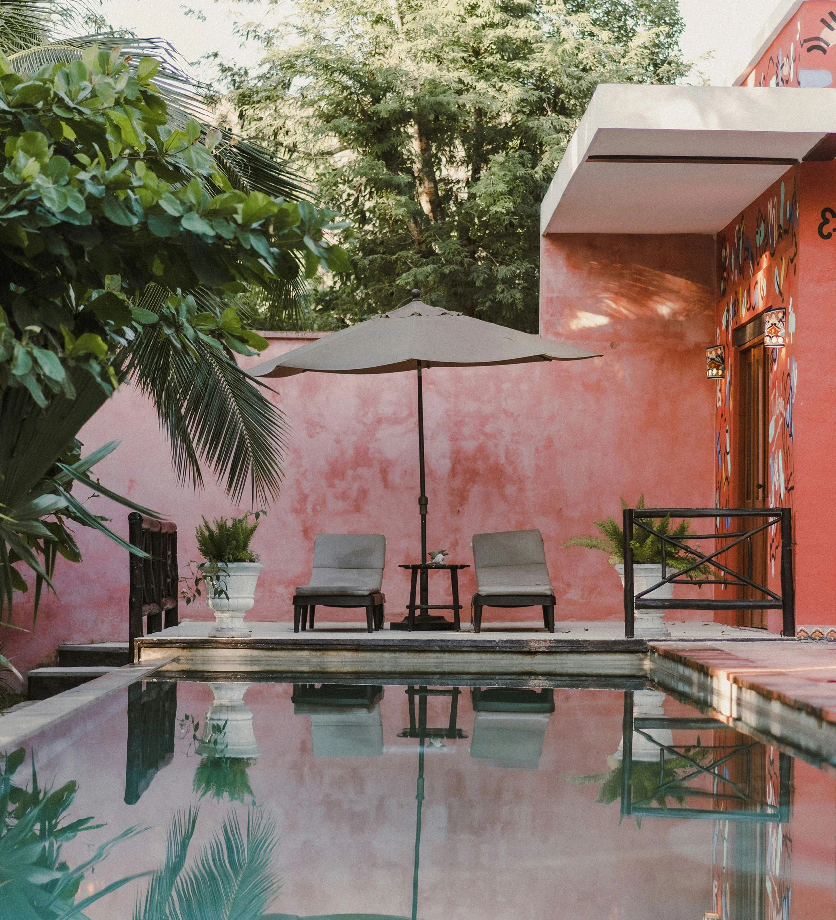 Gay men relaxing by a boutique guesthouse pool near Sitges