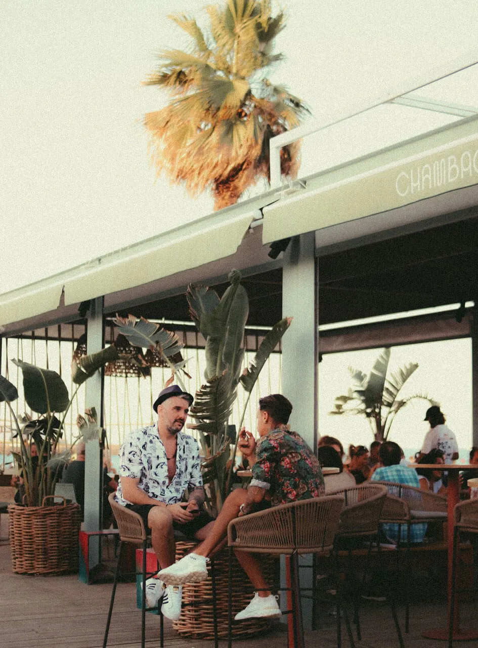 Gay men enjoying the Mediterranean seafront during a day trip to Sitges